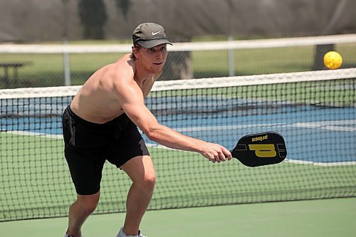 18062025
Chad Nychuk returns the ball while playing pickleball with friend Calen Addison at the Stanley Park pickleball courts on a hot Wednesday afternoon. 
(Tim Smith/The Brandon Sun)