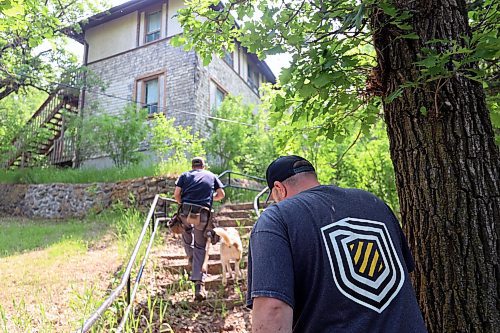 Richard O'Leary, his dog Chance and Geoff Gregoire approach a sanitorium building which is yet to be refurbished. The building is filled with garbage, rotting walls and ceilings, but will be remodelled into modern apartment buildings after an interior demolition and construction. (Connor McDowell/The Brandon Sun)