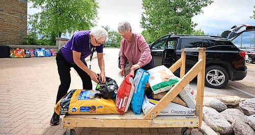 Ruth Bonneville / Free Press
Local - Humane Society give-away
Photo of evacuee Berndina McLean of Bakers Narrows near Flin Flon, picking up a up some free dog food for her two dogs with the help of WHS volunteer Ken Lewicki Monday.
WHS Evacuee Supply pick-up.
Story: The Winnipeg Humane Society hosted a free supply give-away for evacuees at their main location on 45 Hurst Way, Monday. Items included food, dishes, toys, linens, collars and leashes, pet litter, and more, along with helpful volunteers to help people load up!"
June 23rd, 2025