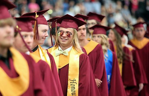 A graduate wears a pair of aviator sunglasses as he stands in line to take his seat at Westoba Place. (Matt Goerzen/The Brandon Sun)