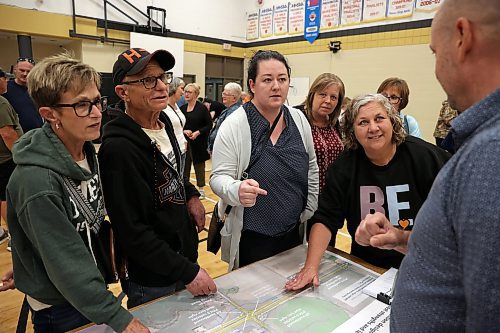 25062025
Carberry and area residents including Jordan Dickson (C) and Debra Steen (right of Dickson), organizers of the local opposition to the proposed RCUT modification to the Trans Canada Highway at the Highway 5 intersection, voice their opposition at the fourth community engagement meeting at Carberry Collegiate on Wednesday evening. 
(Tim Smith/The Brandon Sun)
