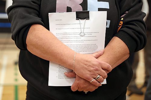 25062025
RM of North Cypress-Langford resident Debra Steen, one of the organizers of the local opposition to the proposed RCUT modification to the Trans Canada Highway at the Highway 5 intersection, holds a petition with 1200 signatures opposing the proposed RCUT at the fourth community engagement meeting involving the province and consultants at Carberry Collegiate on Wednesday evening.
(Tim Smith/The Brandon Sun)