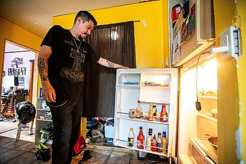 MIKAELA MACKENZIE / FREE PRESS
	
Brett Holland opens the fridge after returning home to Flin Flon on Wednesday, June 25, 2025.

For Nicole Buffie story.
Winnipeg Free Press 2025