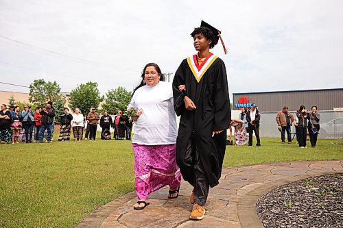 Graduate Marcus Ironman walks with his escort during the honour song at the beginning of Sioux Valley High School’s 2025 graduation ceremony at The Backyard on Aberdeen on Wednesday. (Tim Smith/The Brandon Sun)
