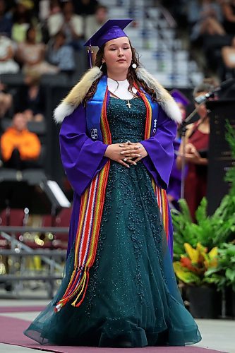 Grade 12 graduate Cali Ferland walks up to receive her diploma during Vincent Massey High School’s 2025 graduation ceremony at Westoba Place on Monday. (Tim Smith/The Brandon Sun)