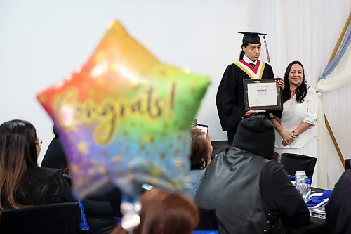 Principal Deborah Asidao presents graduate Aaron Elk with his diploma during Sioux Valley High School’s 2025 graduation ceremony at The Backyard on Aberdeen on Wednesday. (Tim Smith/The Brandon Sun)