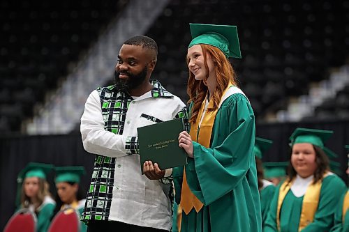Principal Baseswa Nundu presents graduate Emily Clark with her diploma during École Secondaire Neelin High School’s 2025 convocation at Westoba Place on Tuesday afternoon. (Tim Smith/The Brandon Sun)