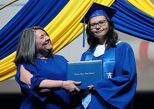 Prairie Hope High School graduate Rhythme Fagnan-Peters (right) receives her diploma from principal Katherine MacFarlane. (Alex Lambert/The Brandon Sun)