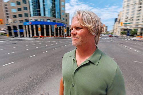 MIKE DEAL / FREE PRESS
Brent Bellamy at Portage Avenue and Main Street the day before the crosswalks are going to become active, allowing people to cross the famous intersection for the first time, legally, since 1979.
We have talked to several longtime proponents of opening Portage and Main as the iconic Winnipeg intersection prepares to welcome pedestrians Friday for the first time in nearly 50 years. Have talked to Glen Murray, Brent Bellamy, Loren Remillard and Adam Dooley. Will lead with Bellamy planning to walk across the intersection in a ‘plebiscite’ T-shirt related to the referendum during Bowman administration.
Reporter: Massimo De Luca-Taronno
250626 - Thursday, June 26, 2025.