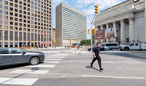 MIKE DEAL / FREE PRESS
Pedestrians use the crosswalks despite the lights not working yet.
Brent Bellamy at Portage Avenue and Main Street the day before the crosswalks are going to become active, allowing people to cross the famous intersection for the first time, legally, since 1979.
We have talked to several longtime proponents of opening Portage and Main as the iconic Winnipeg intersection prepares to welcome pedestrians Friday for the first time in nearly 50 years. Have talked to Glen Murray, Brent Bellamy, Loren Remillard and Adam Dooley. Will lead with Bellamy planning to walk across the intersection in a ‘plebiscite’ T-shirt related to the referendum during Bowman administration.
Reporter: Massimo De Luca-Taronno
250626 - Thursday, June 26, 2025.