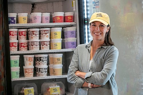 BROOK JONES/FREE PRESS
Fête Ice Cream & Coffee co-owner Élise Page, 37, stands in front of a display freezer filled with pints of flavoured ice cream and ice cream cakes while she is pictured at her storefront location at Unit B, 300 Assiniboine Ave. in Winnipeg, Man., Thursday, June 26, 2025. Page is a co-owner with Teri-Lynn Friesen.