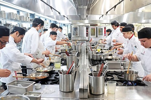 First-year students in the Manitoba Institute of Culinary Arts at Assiniboine College prepare food during class. The college is scaling back culinary arts annual enrolment in September from 48 students to 24. (Tim Smith/The Brandon Sun files)