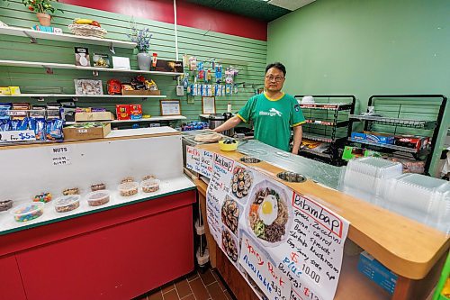 MIKE DEAL / FREE PRESS
While the celebration was taking place above ground, Eric Chi, owner of the convenience story Eshel Tree, in the underground concourse was hard at work getting ready for pedestrians that may want to stop by for some of his Korean snacks.
The day of the official opening of the pedestrian crosswalks at the historic intersection of Portage Avenue and Main Street started with crews clearing away the last of the barriers and impatient people crossing despite those barriers.
The Mayor, Scott Gillingham and several city council members, along with may of the stakeholders for the buildings at each of the corners of the intersection were on hand with several hundred members of the public who cam to cheer and be some of the first to cross after the opening.
Dancing Gabe was on hand to lead a huge crowd around each of the intersections.
Reporter: Tyler Searle
250627 - Friday, June 27, 2025.
