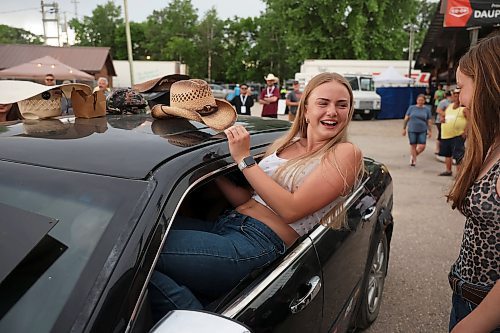 Calli Wilson-Davey of Hamiota tries to fit into a car with as many friends as possible for a contest on Friday. (Tim Smith/The Brandon Sun)