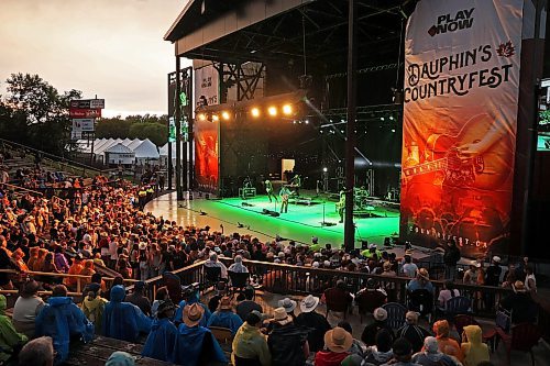 A big crowd watches as Jackson Dean performs with his band on the main stage in the rain at Dauphin’s Countryfest 2025 south of Dauphin on a hot Friday evening. Josh Ross headlined the main-stage later in the night. (Tim Smith/The Brandon Sun)