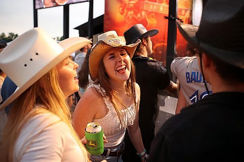 Sammi Rea of Dauphin dances and sings with friends as Jackson Dean performs with his band. (Tim Smith/The Brandon Sun)