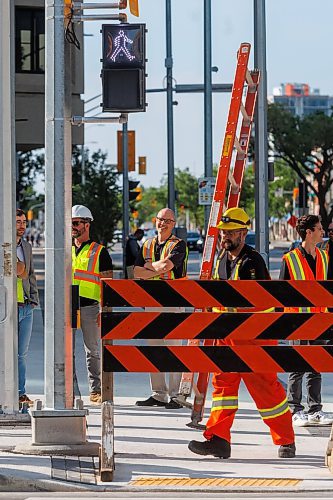 MIKE DEAL / FREE PRESS
The day of the official opening of the pedestrian crosswalks at the historic intersection of Portage Avenue and Main Street started with crews clearing away the last of the barriers and impatient people crossing despite those barriers.
The Mayor, Scott Gillingham and several city council members, along with may of the stakeholders for the buildings at each of the corners of the intersection were on hand with several hundred members of the public who cam to cheer and be some of the first to cross after the opening.
Dancing Gabe was on hand to lead a huge crowd around each of the intersections.
Reporter: Tyler Searle
250627 - Friday, June 27, 2025.