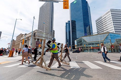 MIKE DEAL / FREE PRESS
The day of the official opening of the pedestrian crosswalks at the historic intersection of Portage Avenue and Main Street started with crews clearing away the last of the barriers and impatient people crossing despite those barriers.
The Mayor, Scott Gillingham and several city council members, along with may of the stakeholders for the buildings at each of the corners of the intersection were on hand with several hundred members of the public who cam to cheer and be some of the first to cross after the opening.
Dancing Gabe was on hand to lead a huge crowd around each of the intersections.
Reporter: Tyler Searle
250627 - Friday, June 27, 2025.