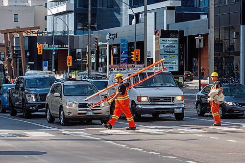 MIKE DEAL / FREE PRESS
The day of the official opening of the pedestrian crosswalks at the historic intersection of Portage Avenue and Main Street started with crews clearing away the last of the barriers and impatient people crossing despite those barriers.
The Mayor, Scott Gillingham and several city council members, along with may of the stakeholders for the buildings at each of the corners of the intersection were on hand with several hundred members of the public who cam to cheer and be some of the first to cross after the opening.
Dancing Gabe was on hand to lead a huge crowd around each of the intersections.
Reporter: Tyler Searle
250627 - Friday, June 27, 2025.