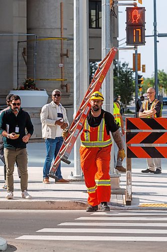 MIKE DEAL / FREE PRESS
The day of the official opening of the pedestrian crosswalks at the historic intersection of Portage Avenue and Main Street started with crews clearing away the last of the barriers and impatient people crossing despite those barriers.
The Mayor, Scott Gillingham and several city council members, along with may of the stakeholders for the buildings at each of the corners of the intersection were on hand with several hundred members of the public who cam to cheer and be some of the first to cross after the opening.
Dancing Gabe was on hand to lead a huge crowd around each of the intersections.
Reporter: Tyler Searle
250627 - Friday, June 27, 2025.