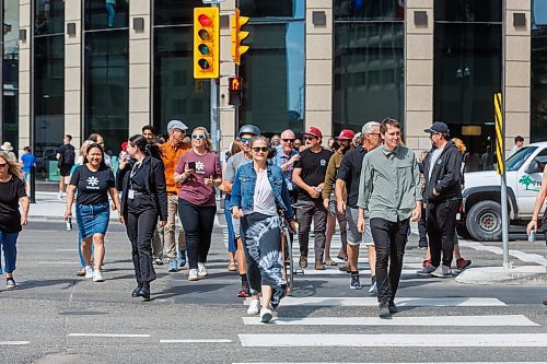 MIKE DEAL / FREE PRESS
Once crossing the street at Portage and Main became official huge crowds of people make their way around to each of the crosswalks.
The day of the official opening of the pedestrian crosswalks at the historic intersection of Portage Avenue and Main Street started with crews clearing away the last of the barriers and impatient people crossing despite those barriers.
The Mayor, Scott Gillingham and several city council members, along with may of the stakeholders for the buildings at each of the corners of the intersection were on hand with several hundred members of the public who cam to cheer and be some of the first to cross after the opening.
Dancing Gabe was on hand to lead a huge crowd around each of the intersections.
Reporter: Tyler Searle
250627 - Friday, June 27, 2025.