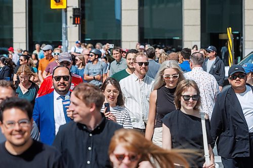 MIKE DEAL / FREE PRESS
Once crossing the street at Portage and Main became official huge crowds of people make their way around to each of the crosswalks.
The day of the official opening of the pedestrian crosswalks at the historic intersection of Portage Avenue and Main Street started with crews clearing away the last of the barriers and impatient people crossing despite those barriers.
The Mayor, Scott Gillingham and several city council members, along with may of the stakeholders for the buildings at each of the corners of the intersection were on hand with several hundred members of the public who cam to cheer and be some of the first to cross after the opening.
Dancing Gabe was on hand to lead a huge crowd around each of the intersections.
Reporter: Tyler Searle
250627 - Friday, June 27, 2025.