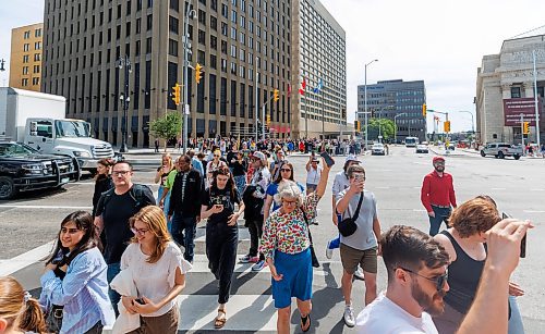 MIKE DEAL / FREE PRESS
Once crossing the street at Portage and Main became official huge crowds of people make their way around to each of the crosswalks.
The day of the official opening of the pedestrian crosswalks at the historic intersection of Portage Avenue and Main Street started with crews clearing away the last of the barriers and impatient people crossing despite those barriers.
The Mayor, Scott Gillingham and several city council members, along with may of the stakeholders for the buildings at each of the corners of the intersection were on hand with several hundred members of the public who cam to cheer and be some of the first to cross after the opening.
Dancing Gabe was on hand to lead a huge crowd around each of the intersections.
Reporter: Tyler Searle
250627 - Friday, June 27, 2025.