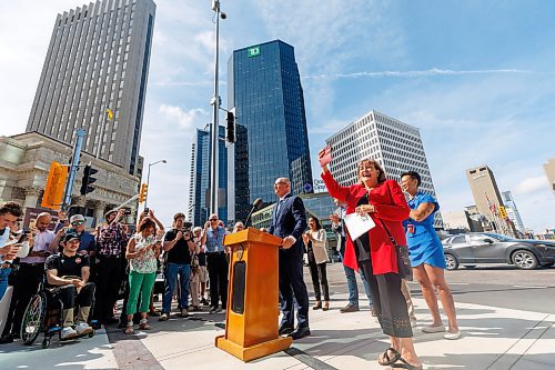MIKE DEAL / FREE PRESS
Mayor Scott Gillingham speaks to the assembled crowd before walking across the street making the official opening of the pedestrian crosswalks.
The day of the official opening of the pedestrian crosswalks at the historic intersection of Portage Avenue and Main Street started with crews clearing away the last of the barriers and impatient people crossing despite those barriers.
The Mayor, Scott Gillingham and several city council members, along with may of the stakeholders for the buildings at each of the corners of the intersection were on hand with several hundred members of the public who cam to cheer and be some of the first to cross after the opening.
Dancing Gabe was on hand to lead a huge crowd around each of the intersections.
Reporter: Tyler Searle
250627 - Friday, June 27, 2025.