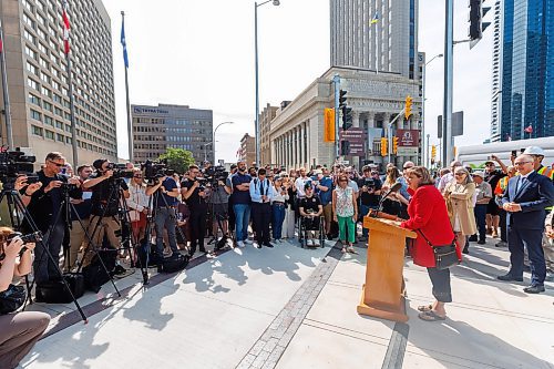 MIKE DEAL / FREE PRESS
City Councillor Janice Lukes speaks during the official opening.
The day of the official opening of the pedestrian crosswalks at the historic intersection of Portage Avenue and Main Street started with crews clearing away the last of the barriers and impatient people crossing despite those barriers.
The Mayor, Scott Gillingham and several city council members, along with may of the stakeholders for the buildings at each of the corners of the intersection were on hand with several hundred members of the public who cam to cheer and be some of the first to cross after the opening.
Dancing Gabe was on hand to lead a huge crowd around each of the intersections.
Reporter: Tyler Searle
250627 - Friday, June 27, 2025.