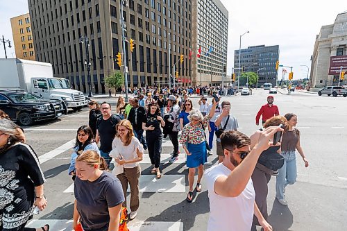 MIKE DEAL / FREE PRESS
Once crossing the street at Portage and Main became official huge crowds of people make their way around to each of the crosswalks.
The day of the official opening of the pedestrian crosswalks at the historic intersection of Portage Avenue and Main Street started with crews clearing away the last of the barriers and impatient people crossing despite those barriers.
The Mayor, Scott Gillingham and several city council members, along with may of the stakeholders for the buildings at each of the corners of the intersection were on hand with several hundred members of the public who cam to cheer and be some of the first to cross after the opening.
Dancing Gabe was on hand to lead a huge crowd around each of the intersections.
Reporter: Tyler Searle
250627 - Friday, June 27, 2025.