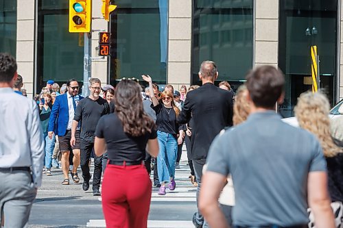 MIKE DEAL / FREE PRESS
Once crossing the street at Portage and Main became official huge crowds of people make their way around to each of the crosswalks.
The day of the official opening of the pedestrian crosswalks at the historic intersection of Portage Avenue and Main Street started with crews clearing away the last of the barriers and impatient people crossing despite those barriers.
The Mayor, Scott Gillingham and several city council members, along with may of the stakeholders for the buildings at each of the corners of the intersection were on hand with several hundred members of the public who cam to cheer and be some of the first to cross after the opening.
Dancing Gabe was on hand to lead a huge crowd around each of the intersections.
Reporter: Tyler Searle
250627 - Friday, June 27, 2025.