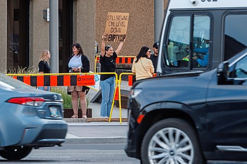 MIKE DEAL / FREE PRESS
Haley Yurman, brand and marketing leader for Empty Cup which has a storefront in the underground concourse at Portage and Main, holds up a sign reminding people that they still exist.
The day of the official opening of the pedestrian crosswalks at the historic intersection of Portage Avenue and Main Street started with crews clearing away the last of the barriers and impatient people crossing despite those barriers.
The Mayor, Scott Gillingham and several city council members, along with may of the stakeholders for the buildings at each of the corners of the intersection were on hand with several hundred members of the public who cam to cheer and be some of the first to cross after the opening.
Dancing Gabe was on hand to lead a huge crowd around each of the intersections.
Reporter: Tyler Searle
250627 - Friday, June 27, 2025.