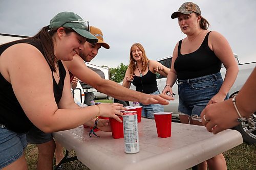 27062025
A group of friends from Winnipeg play  a game called stack cup at their campsite at Dauphin&#x2019;s Countryfest 2025 south of Dauphin, Manitoba on a hot Friday evening. 
(Tim Smith/The Brandon Sun)