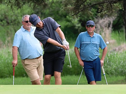 Brett Nohr chips onto the green on the 18th hole as Don Thomson, left, and Warren Watt look on during the Birt Cup on Friday afternoon at the Wheat City Golf Course. The annual tournament has raised hundreds of thousands of dollars for the community since it began in 2008. The final tally for this year's event isn't available yet. (Perry Bergson/The Brandon Sun)
July 4, 2025