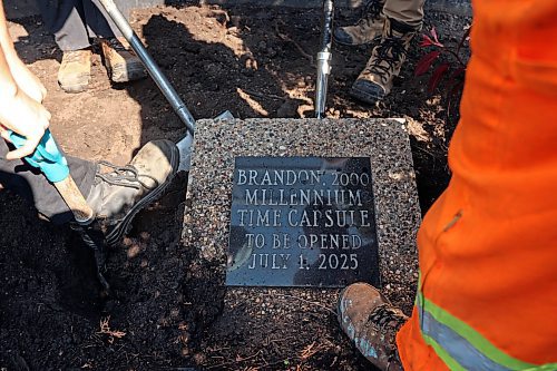 04072025
City of Brandon workers dig up the Brandon 2000 Millennium Time Capsule, which was buried in a garden outside Brandon City Hall 25 years ago. The time capsule was created by the United Commercial Travelers (UCT) as part of Brandon City Council’s call-out for local organizations to create ways to celebrate the millennium. Brandon Mayor Jeff Fawcett opened the capsule and unveiled the contents to the crowd at city hall. (Tim Smith/The Brandon Sun)