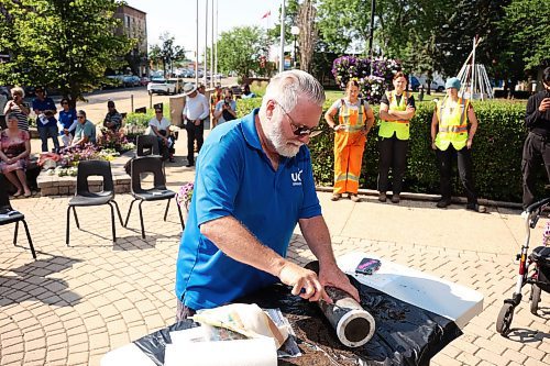 04072025
Eldon Schmitz with the United Commercial Travelers (UCT) prepares to open the Brandon 2000 Millennium Time Capsule, which was buried in a garden outside Brandon City Hall 25 years ago. The time capsule was created by the United Commercial Travelers (UCT) as part of Brandon City Council’s call-out for local organizations to create ways to celebrate the millennium. Brandon Mayor Jeff Fawcett unveiled the contents to the crowd at city hall. (Tim Smith/The Brandon Sun)