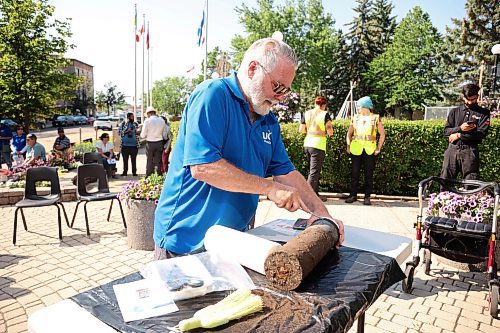 04072025
Eldon Schmitz with the United Commercial Travelers (UCT) prepares to open the Brandon 2000 Millennium Time Capsule, which was buried in a garden outside Brandon City Hall 25 years ago. The time capsule was created by the United Commercial Travelers (UCT) as part of Brandon City Council’s call-out for local organizations to create ways to celebrate the millennium. Brandon Mayor Jeff Fawcett unveiled the contents to the crowd at city hall.  (Tim Smith/The Brandon Sun)