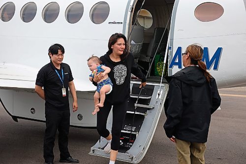 04072025
Shannon Dysart steps off a plane with family members at the Brandon Municipal Airport on Friday afternoon after being evacuated from Lynn Lake, Manitoba due to wildfires threatening the community. This is the second time this summer that Lynn Lake has been evacuated.   (Tim Smith/The Brandon Sun
