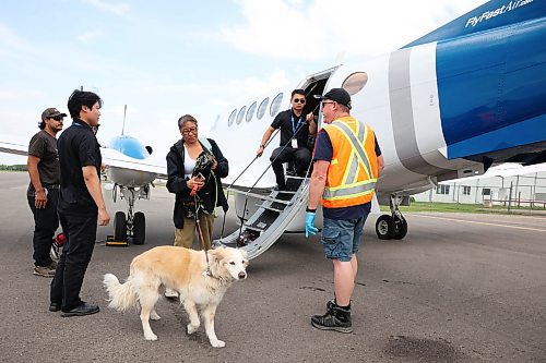 04072025
Delores Halkett of Lynn Lake, Manitoba and her dog Penny step off a plane at the Brandon Municipal Airport on Friday afternoon after being evacuated from Lynn Lake due to wildfires threatening the community. This is the second time this summer that Lynn Lake has been evacuated. (Tim Smith/The Brandon Sun