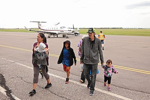 04072025
Nikita Moose, Trent Farrow and their seven children arrive at the Brandon Municipal Airport on Friday afternoon after being evacuated from Lynn Lake, Manitoba due to wildfires threatening the community. This is the second time this summer that Lynn Lake has been evacuated. (Tim Smith/The Brandon Sun