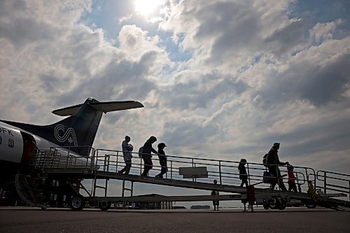 04072025
Evacuees from Lynn Lake, Manitoba arrive at the Brandon Municipal Airport on Friday afternoon after being evacuated from Lynn Lake due to wildfires threatening the community. This is the second time this summer that Lynn Lake has been evacuated. (Tim Smith/The Brandon Sun