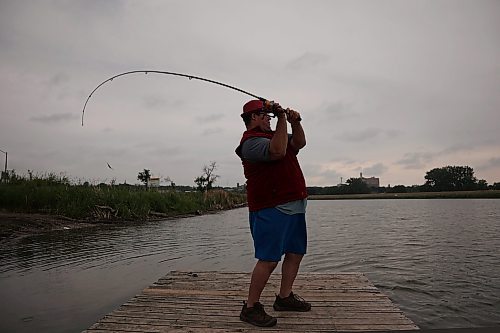 07072025
Ryan Houston fishes the Assiniboine River from the dock at Dinsdale Park on a cool and overcast Monday.
(Tim Smith/The Brandon Sun)