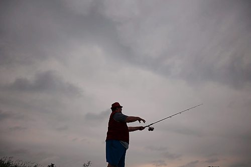 07072025
Ryan Houston fishes the Assiniboine River from the dock at Dinsdale Park on a cool and overcast Monday.
(Tim Smith/The Brandon Sun)
