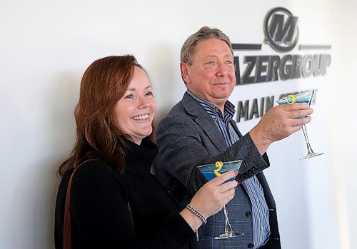 Mazergroup president and CEO Bob Mazer, accompanied by vice-president, people and culture Karen MacDonald, makes a toast in honour of Assiniboine Community College naming a portion of the Len Evans Centre for Trades and Technology after his company. The blue and yellow martinis were made in honour of Mazergroup, marking the fact that it is the largest New Holland dealership group in Canada. Blue and yellow are New Holland's colours. (Ian Hitchen/The Brandon Sun)