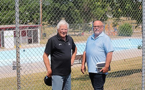 Brandon Ward 9 City Coun. Glen Parker (left) and general manager of operations Todd Burton stand outside the fence at the Kinsmen Pool in Rideau Park. (Michele McDougall/The Brandon Sun)