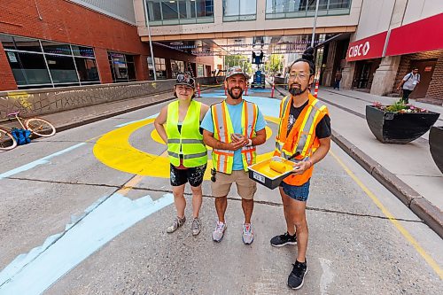 MIKE DEAL / FREE PRESS
(From left) Artist, Alex Plante, Stephen Dorge, project manager, and Takashi Iwasaki, artistic lead for the mural designs for a four-block stretch of Graham between Carlton and Garry Street Tuesday morning.
250708 - Tuesday, July 08, 2025.