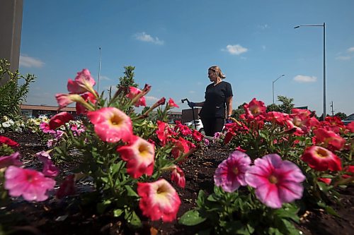 08072025
Housekeeping worker Maryna Fisun of Ukraine waters flowers outside the Travelodge on 18th Street N. in Brandon on Tuesday.
(Tim Smith/The Brandon Sun)