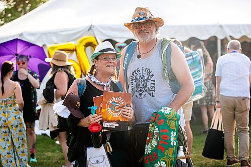 MIKAELA MACKENZIE / FREE PRESS
	
Ally Robertson and Todd Angus with their freshly bought merch at Folk Fest on Thursday, July 10, 2025. 

For folk fest story.
Winnipeg Free Press 2025