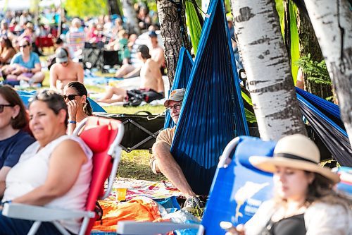 MIKAELA MACKENZIE / FREE PRESS
	
Tim Philippi watches the music from his hammock at Folk Fest on Thursday, July 10, 2025. 

For folk fest story.
Winnipeg Free Press 2025