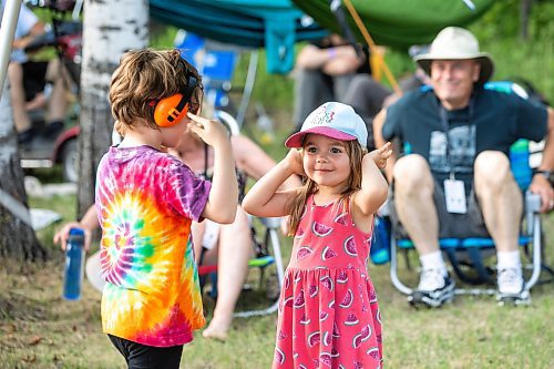 MIKAELA MACKENZIE / FREE PRESS
	
Mariel Ladouceur (five, left) and Lauriane Bellefeuille (four) listen to the music at Folk Fest on Thursday, July 10, 2025. 

For folk fest story.
Winnipeg Free Press 2025